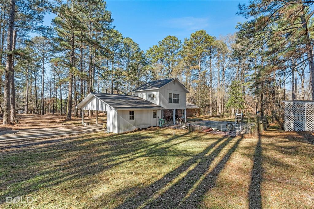 447 Burrow Lane Cotton Valley, LA 71018 - Photo 37 of 39 a view of a house with a yard covered in snow