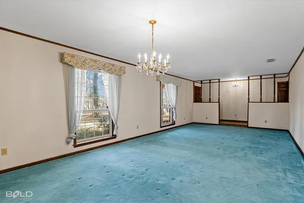 a view of a livingroom with an empty space and a window