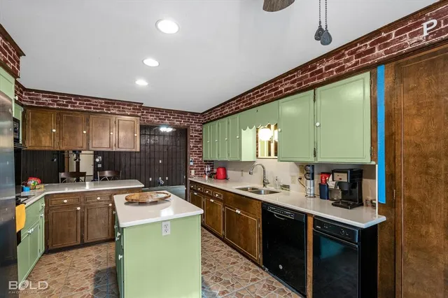 a kitchen with sink cabinets and stainless steel appliances