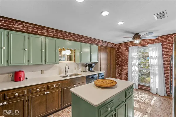 a kitchen with a sink a stove and a refrigerator