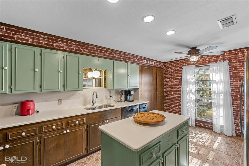 447 Burrow Lane Cotton Valley, LA 71018 - Photo 9 of 39 a kitchen with a sink a stove and a refrigerator
