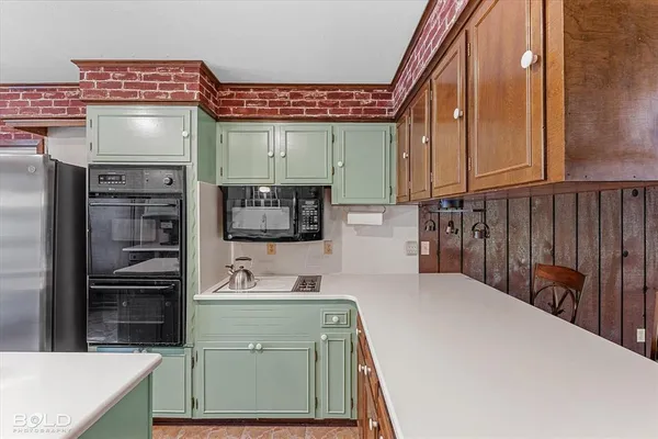a kitchen with stainless steel appliances a sink and cabinets