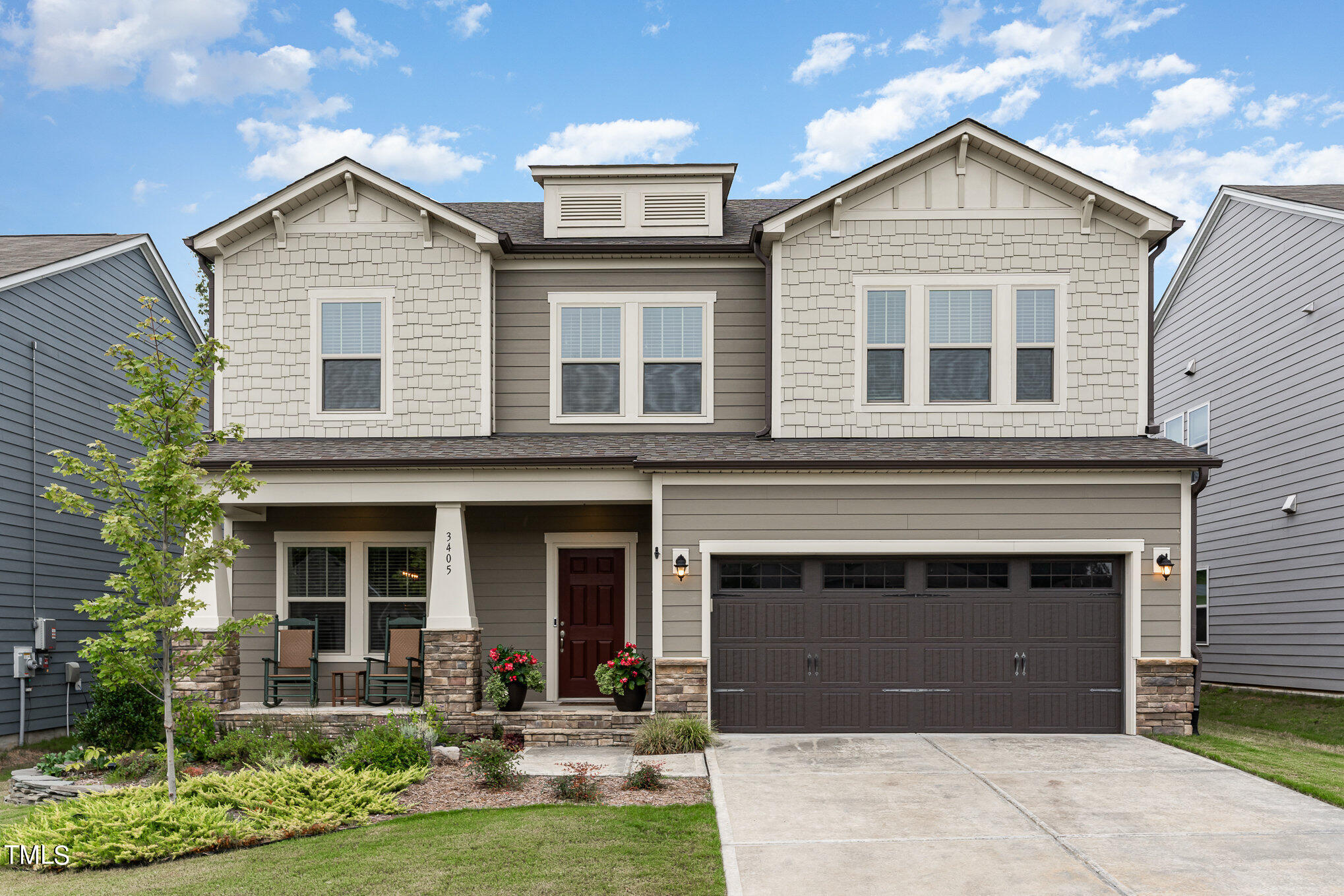 a front view of a house with yard and garage