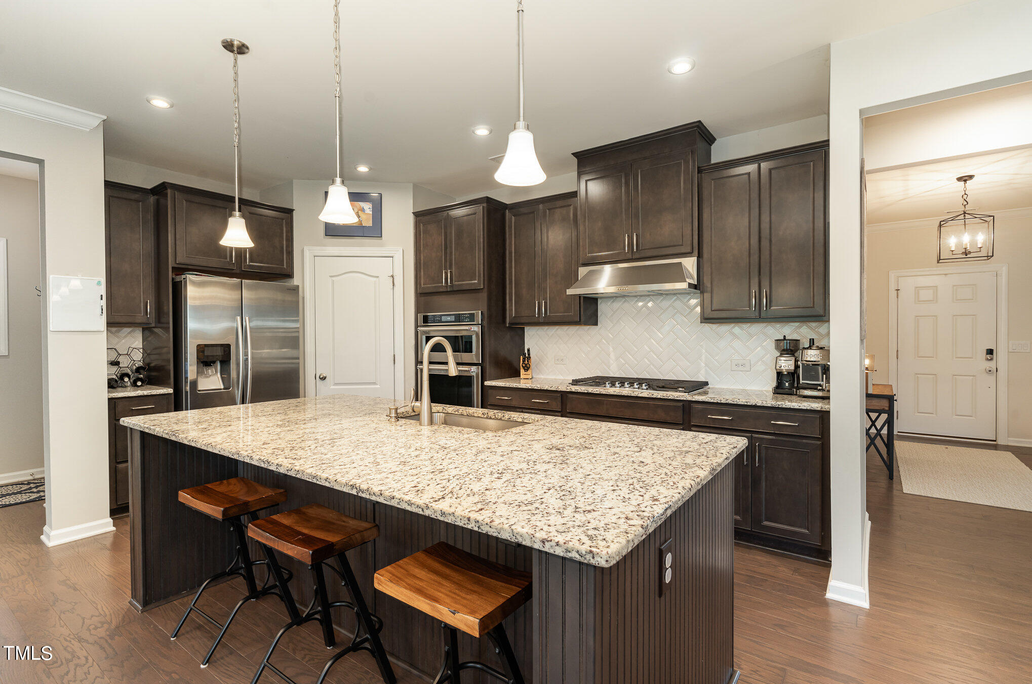 3405 Barn Road Apex, NC 27502 - Photo 12 of 38 a kitchen with center island and stainless steel appliances