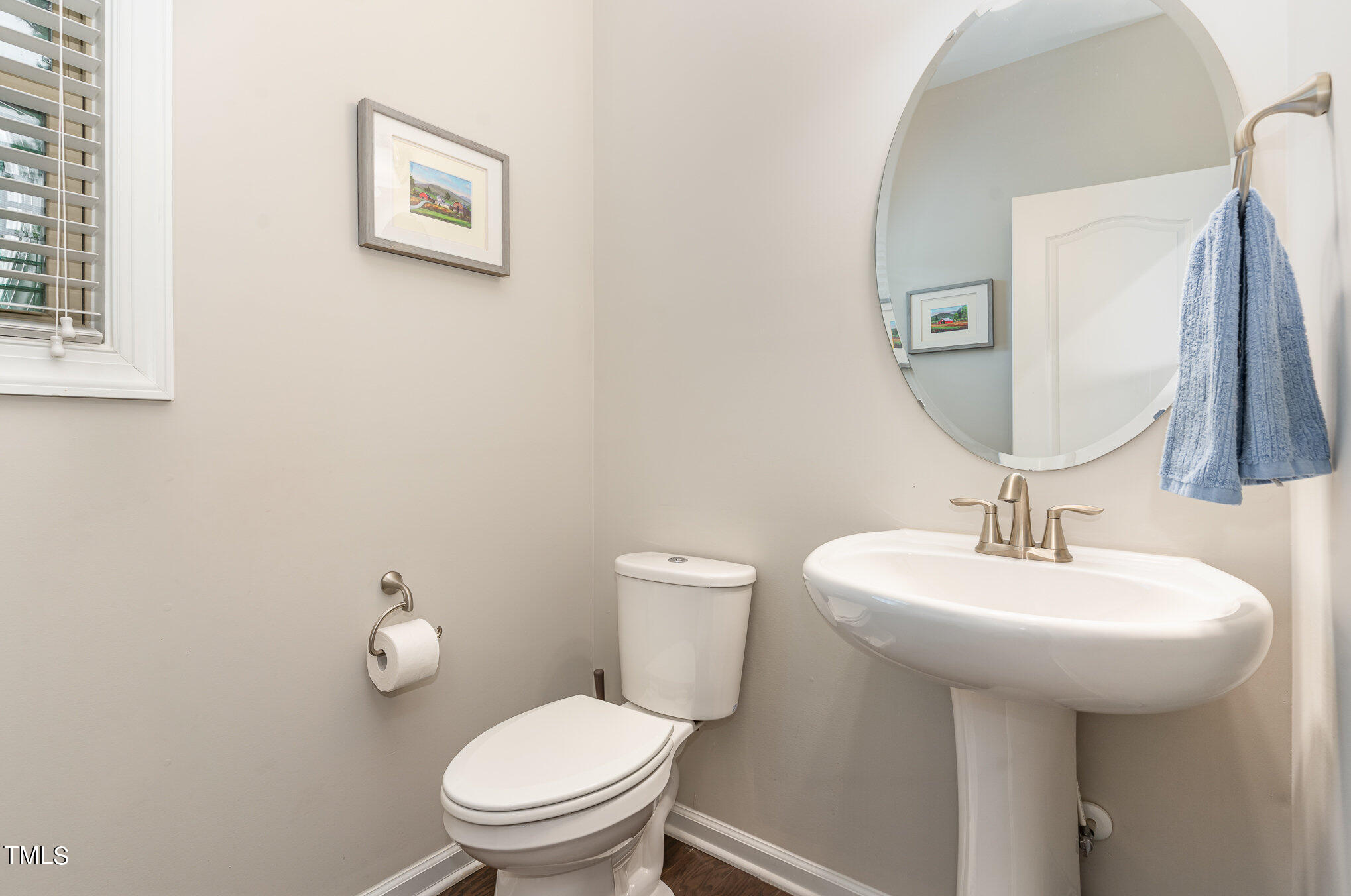 3405 Barn Road Apex, NC 27502 - Photo 19 of 38 a bathroom with a toilet sink and mirror