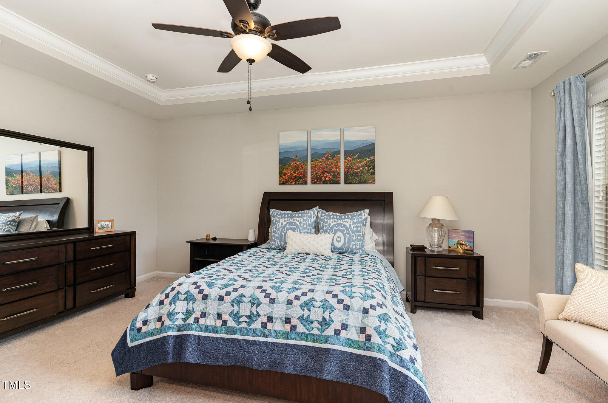 3405 Barn Road Apex, NC 27502 - Photo 21 of 38 a bedroom with a bed and a chandelier