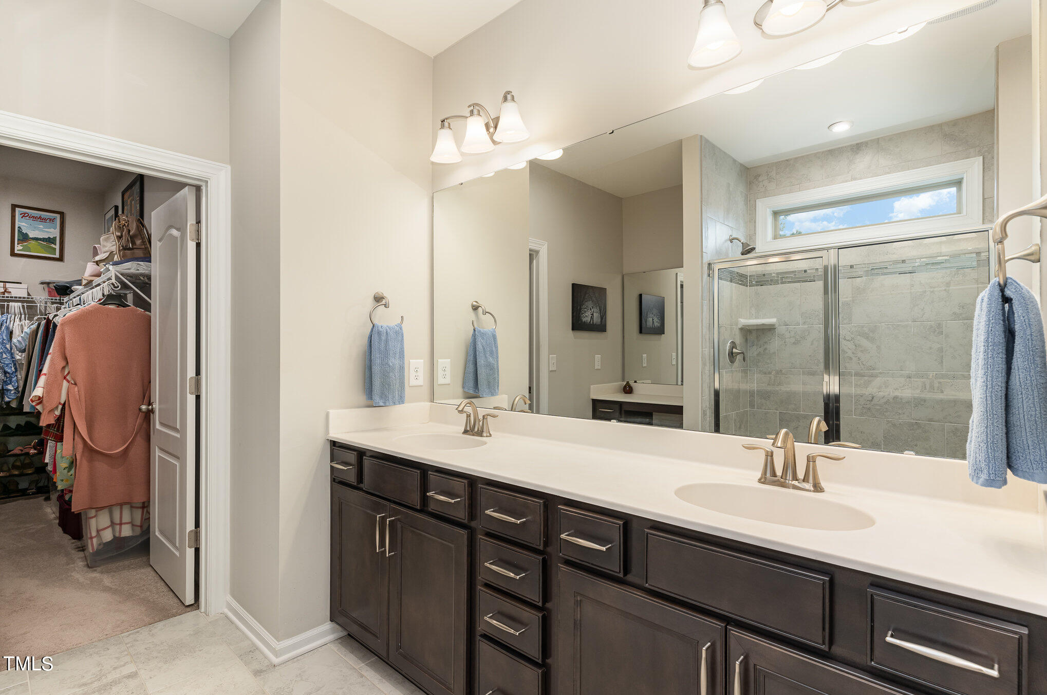 3405 Barn Road Apex, NC 27502 - Photo 23 of 38 a bathroom with a double vanity sink and a mirror
