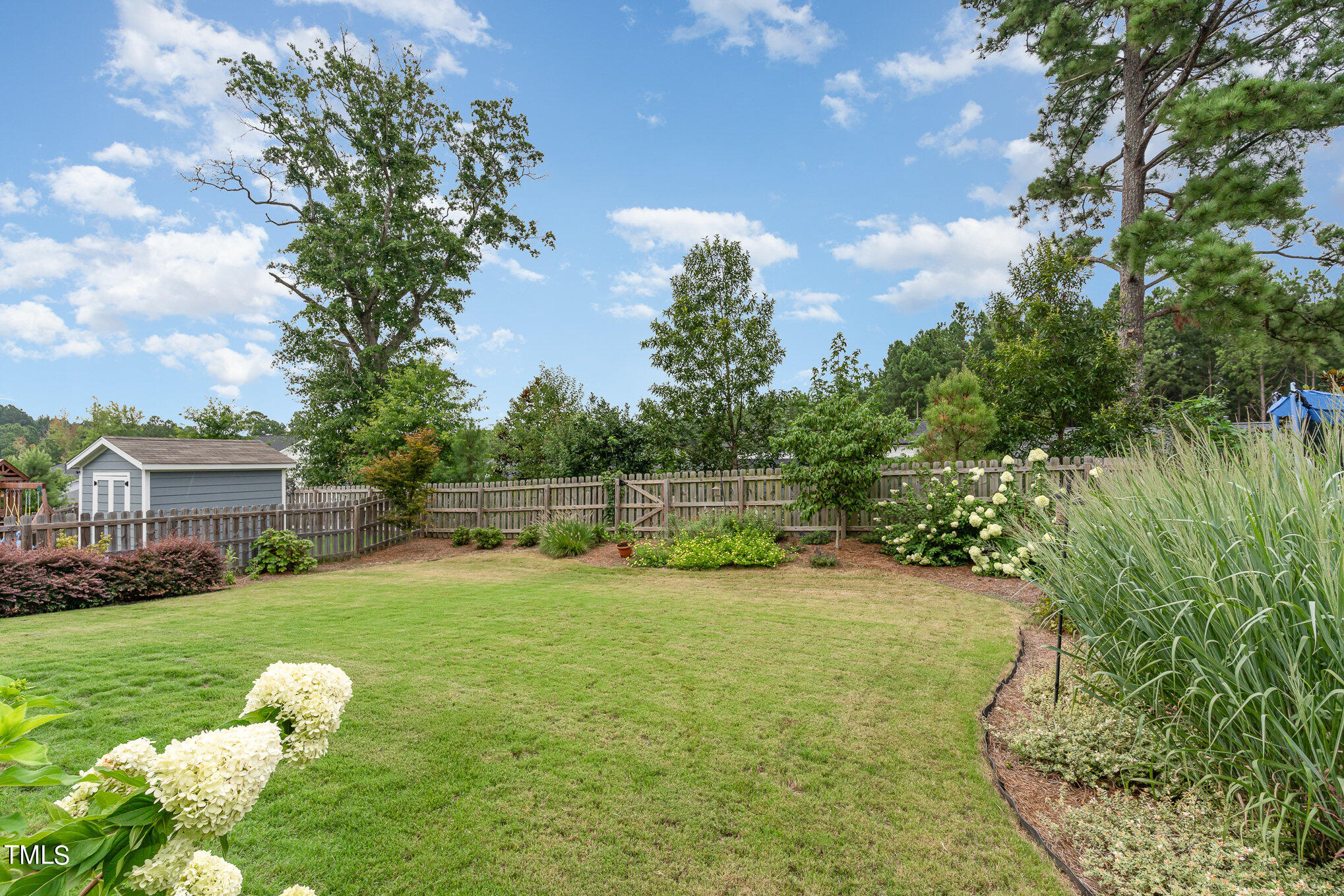 3405 Barn Road Apex, NC 27502 - Photo 35 of 38 a backyard of a house with lots of green space