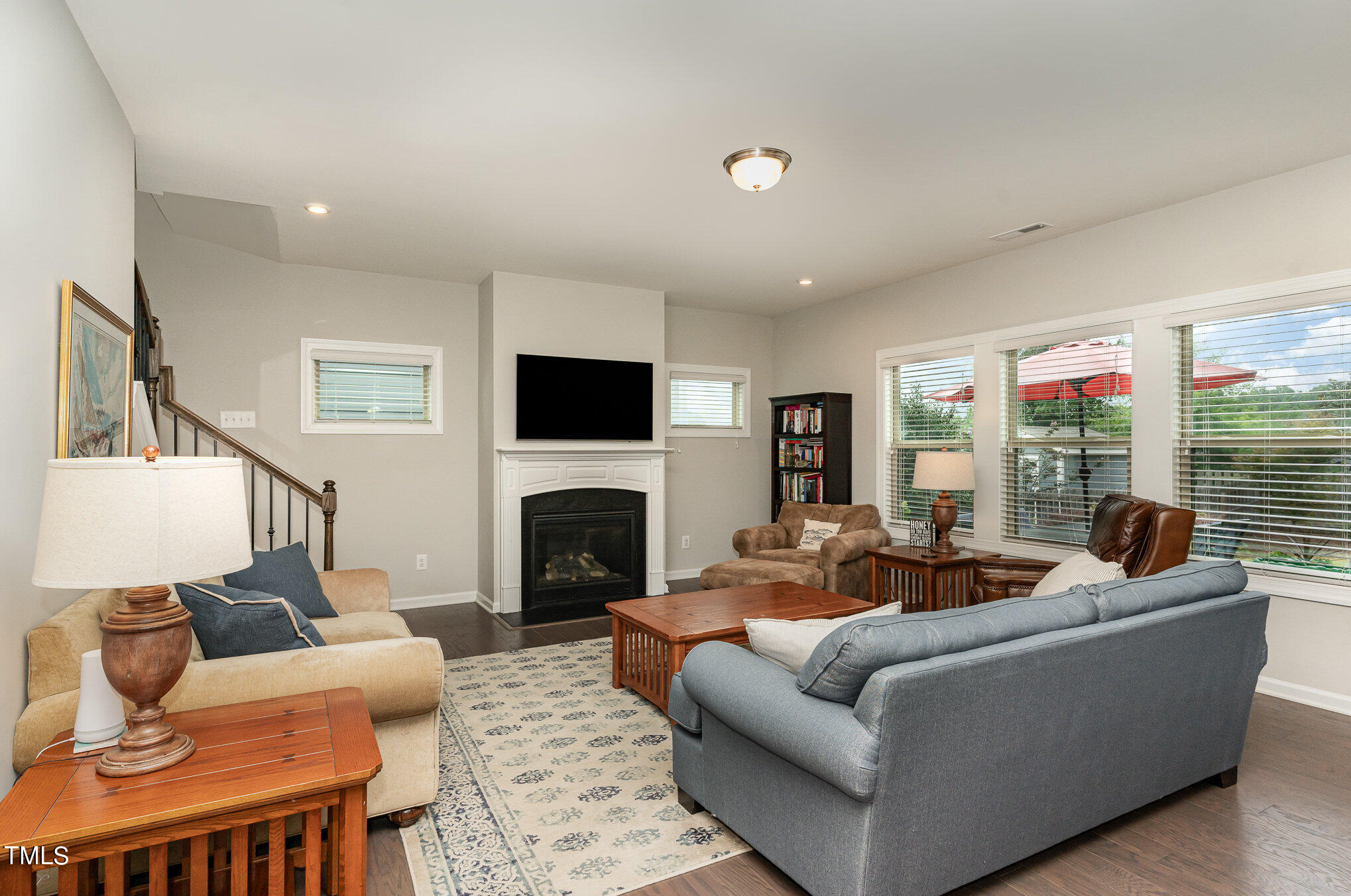 3405 Barn Road Apex, NC 27502 - Photo 8 of 38 a living room with furniture flat screen tv and a fireplace