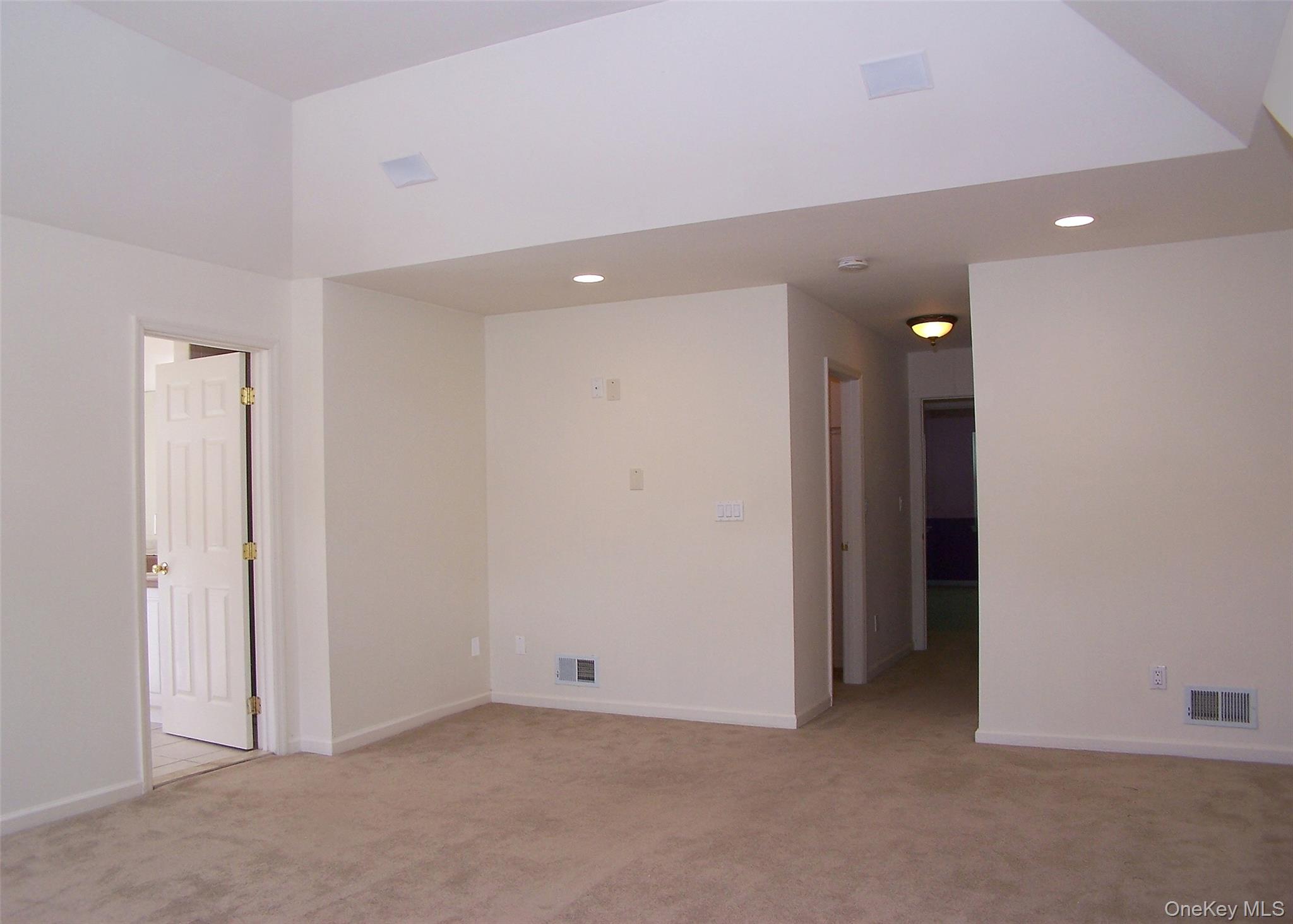 63 Sunflower Ridge Road Centereach, NY 11720 - Photo 11 of 24 an empty room with closet and a hallway