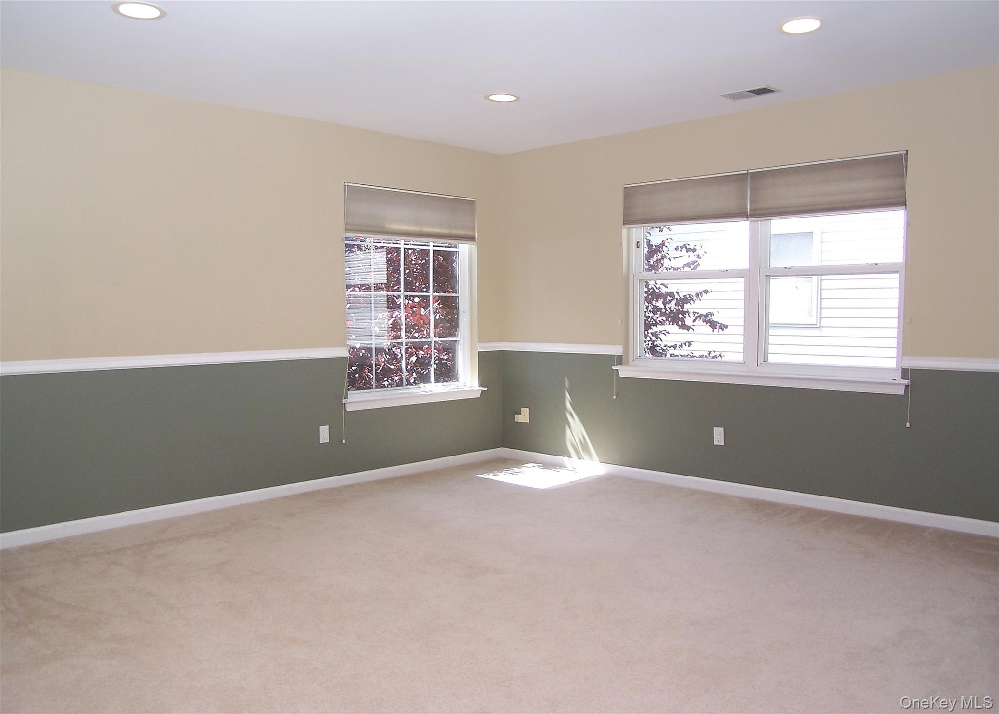 63 Sunflower Ridge Road Centereach, NY 11720 - Photo 14 of 24 an empty room with windows