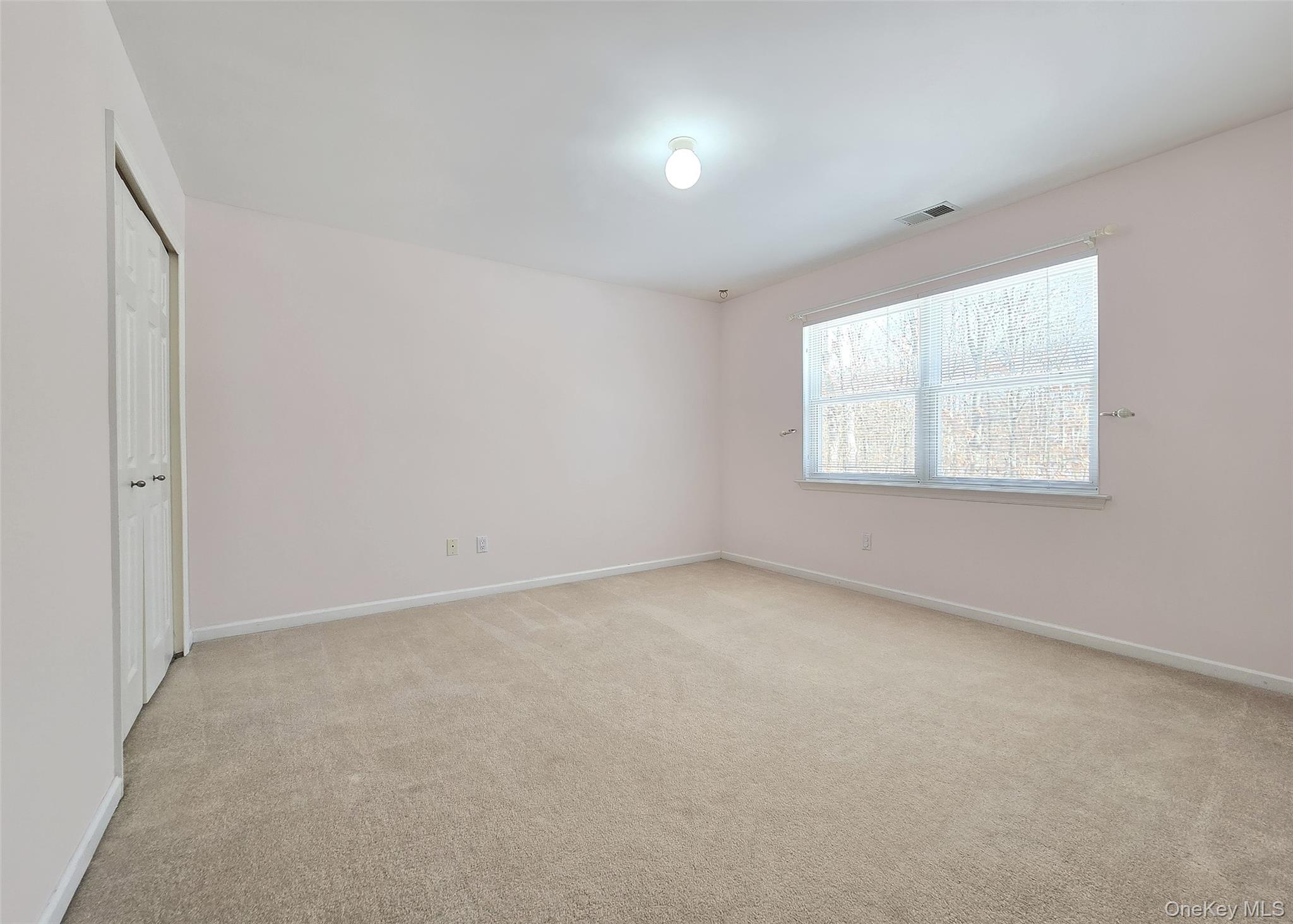 63 Sunflower Ridge Road Centereach, NY 11720 - Photo 15 of 23 an empty room with windows