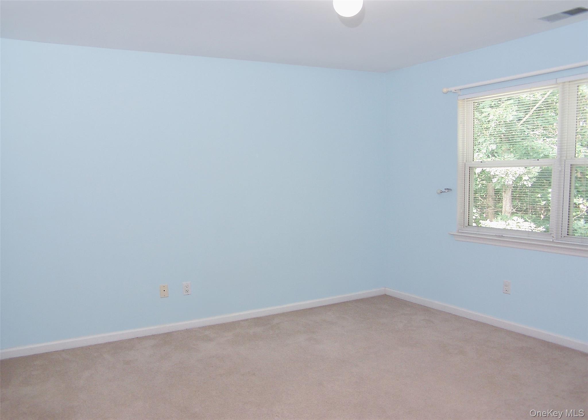 63 Sunflower Ridge Road Centereach, NY 11720 - Photo 16 of 24 an empty room with a window