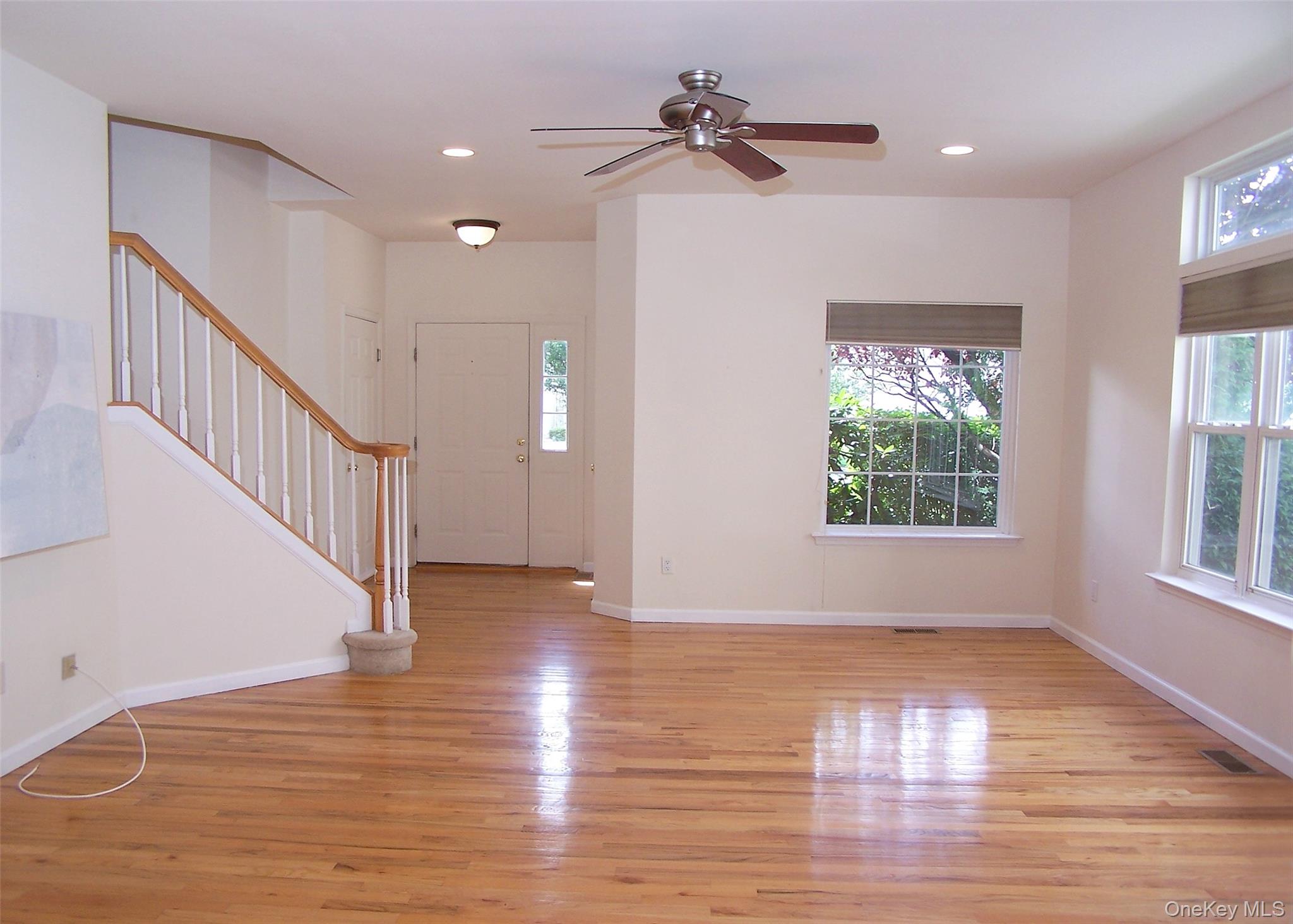 63 Sunflower Ridge Road Centereach, NY 11720 - Photo 2 of 24 a view of an entryway with wooden floor and windows