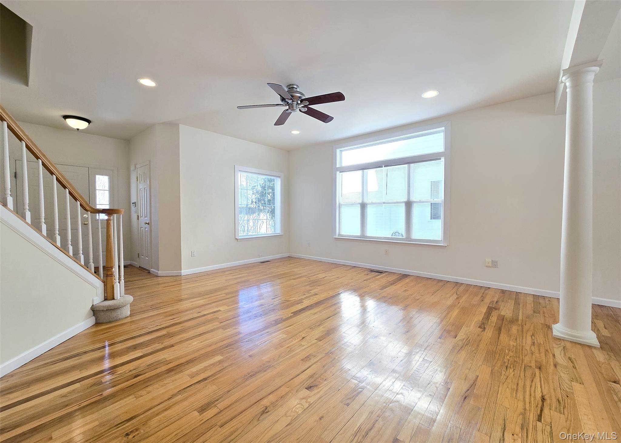 63 Sunflower Ridge Road Centereach, NY 11720 - Photo 3 of 23 wooden floor in an empty room with a window