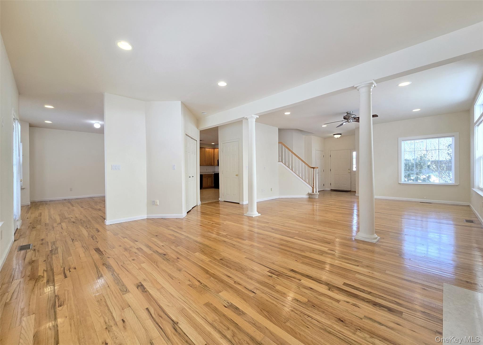 63 Sunflower Ridge Road Centereach, NY 11720 - Photo 4 of 23 a view of a hallway with wooden floor and a refrigerator