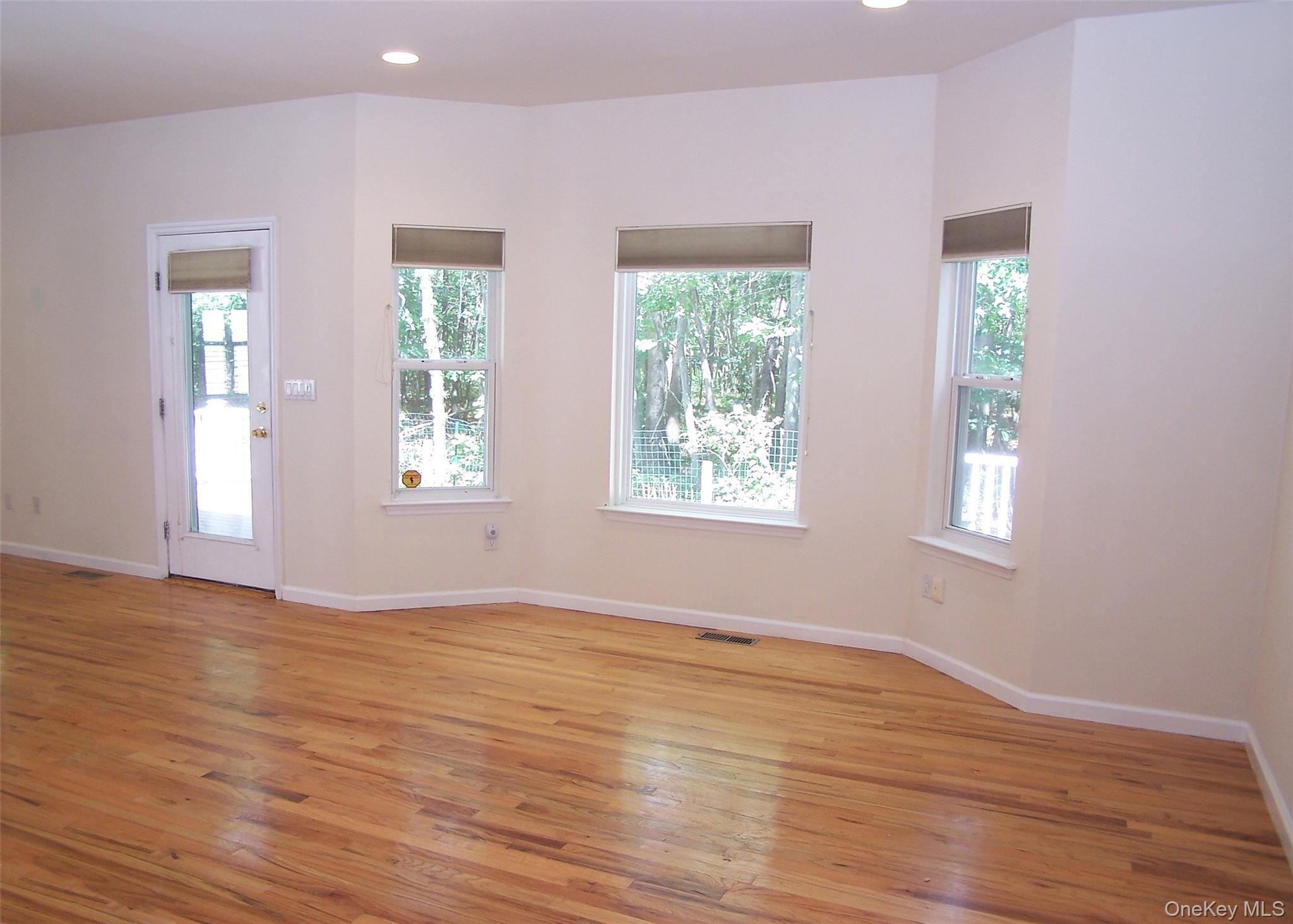 63 Sunflower Ridge Road Centereach, NY 11720 - Photo 9 of 24 a view of an empty room with wooden floor and a window