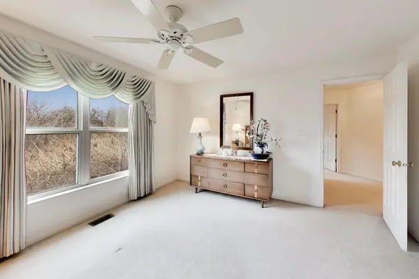 a view of room with window and a ceiling fan
