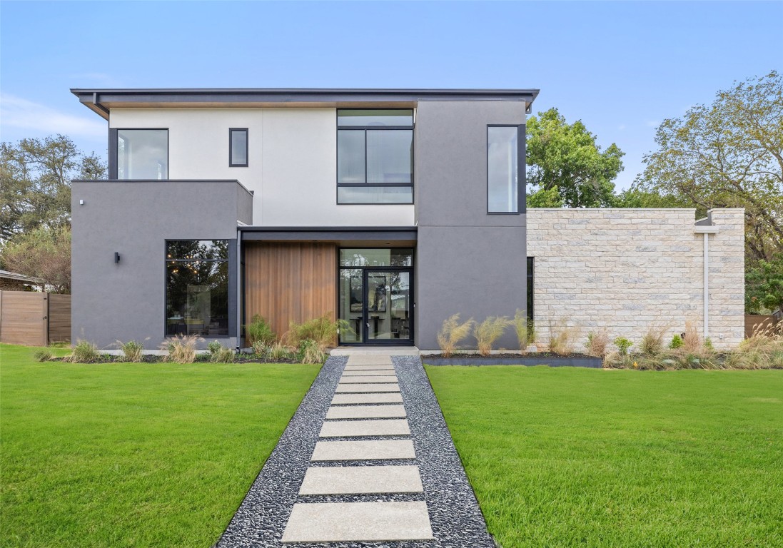 304 Blue Ridge Trail Austin, TX 78746 - Photo 11 of 40 a front view of a house with a yard and garage