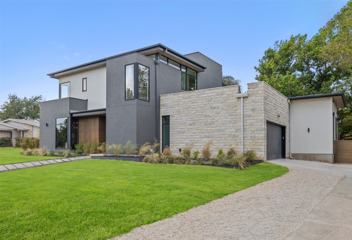 304 Blue Ridge Trail Austin, TX 78746 - Photo 12 of 40 a front view of a house with a yard and trees
