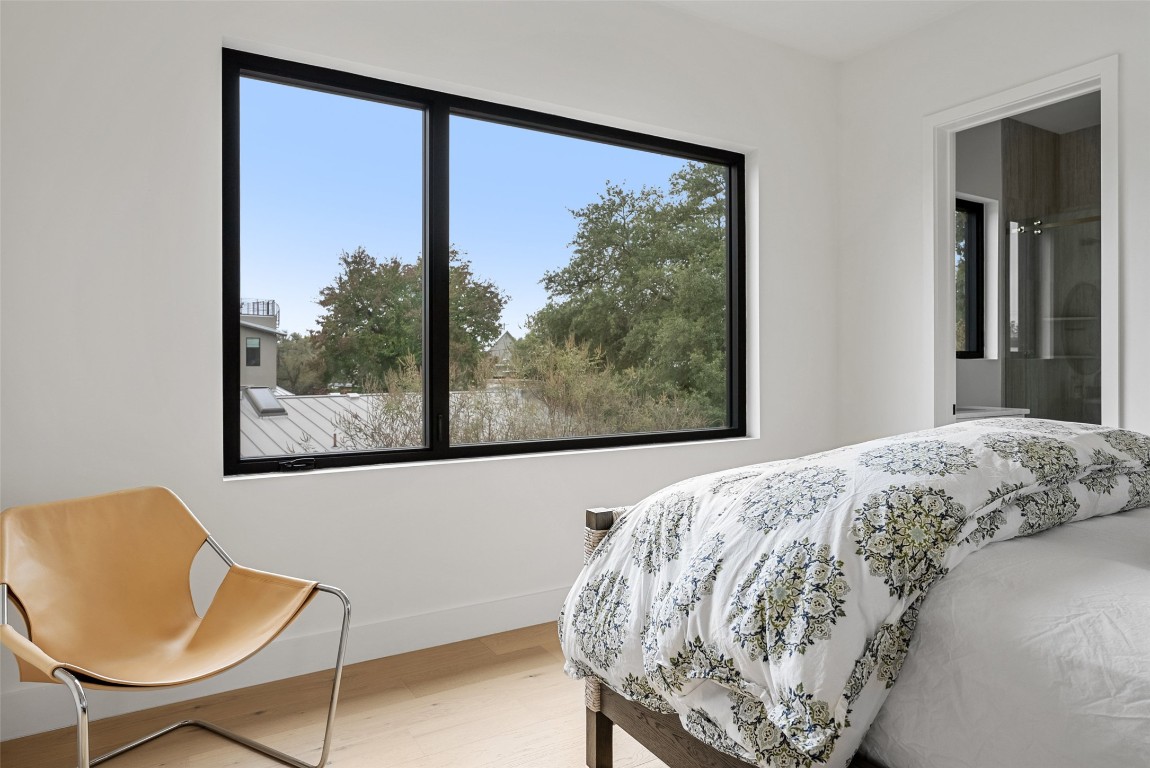 304 Blue Ridge Trail Austin, TX 78746 - Photo 25 of 40 a view of a bedroom with furniture and a window