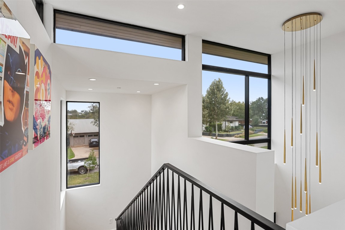 304 Blue Ridge Trail Austin, TX 78746 - Photo 28 of 40 a view of a hallway with wooden floor and a window