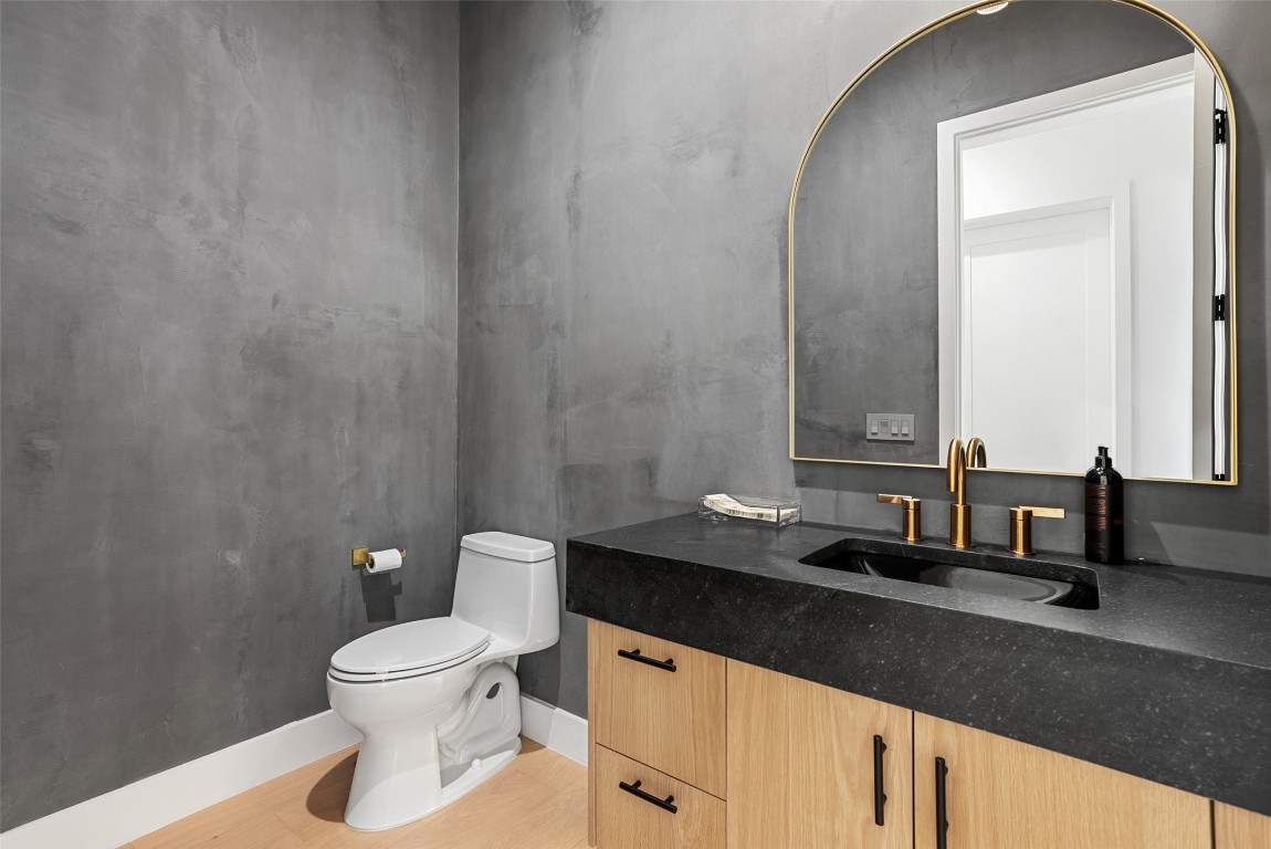 304 Blue Ridge Trail Austin, TX 78746 - Photo 29 of 40 a bathroom with a granite countertop sink and a mirror