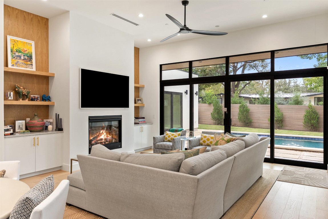 304 Blue Ridge Trail Austin, TX 78746 - Photo 5 of 40 a living room with furniture a flat screen tv and a fireplace