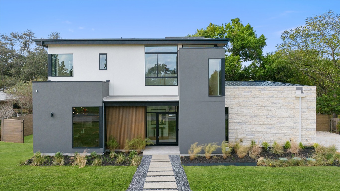 304 Blue Ridge Trail Austin, TX 78746 - Photo 9 of 40 a front view of a house with a yard