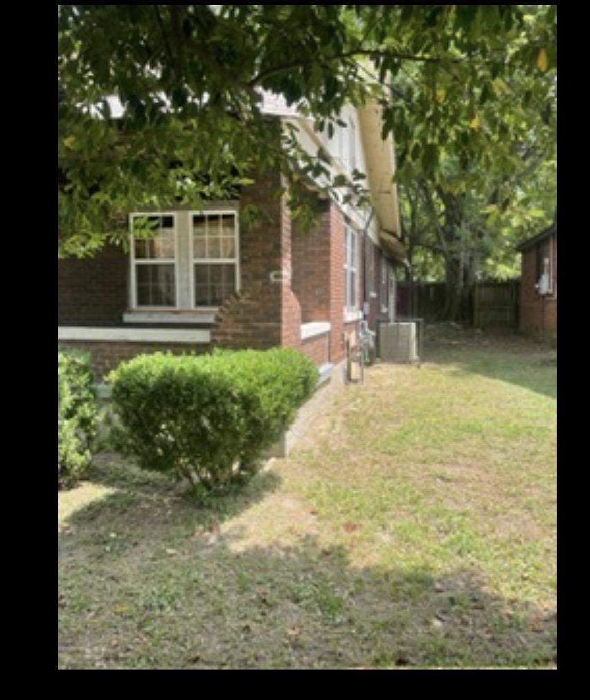 776 Newell Road Memphis, TN 38111 - Photo 2 of 5 a backyard of a house with yard and outdoor seating