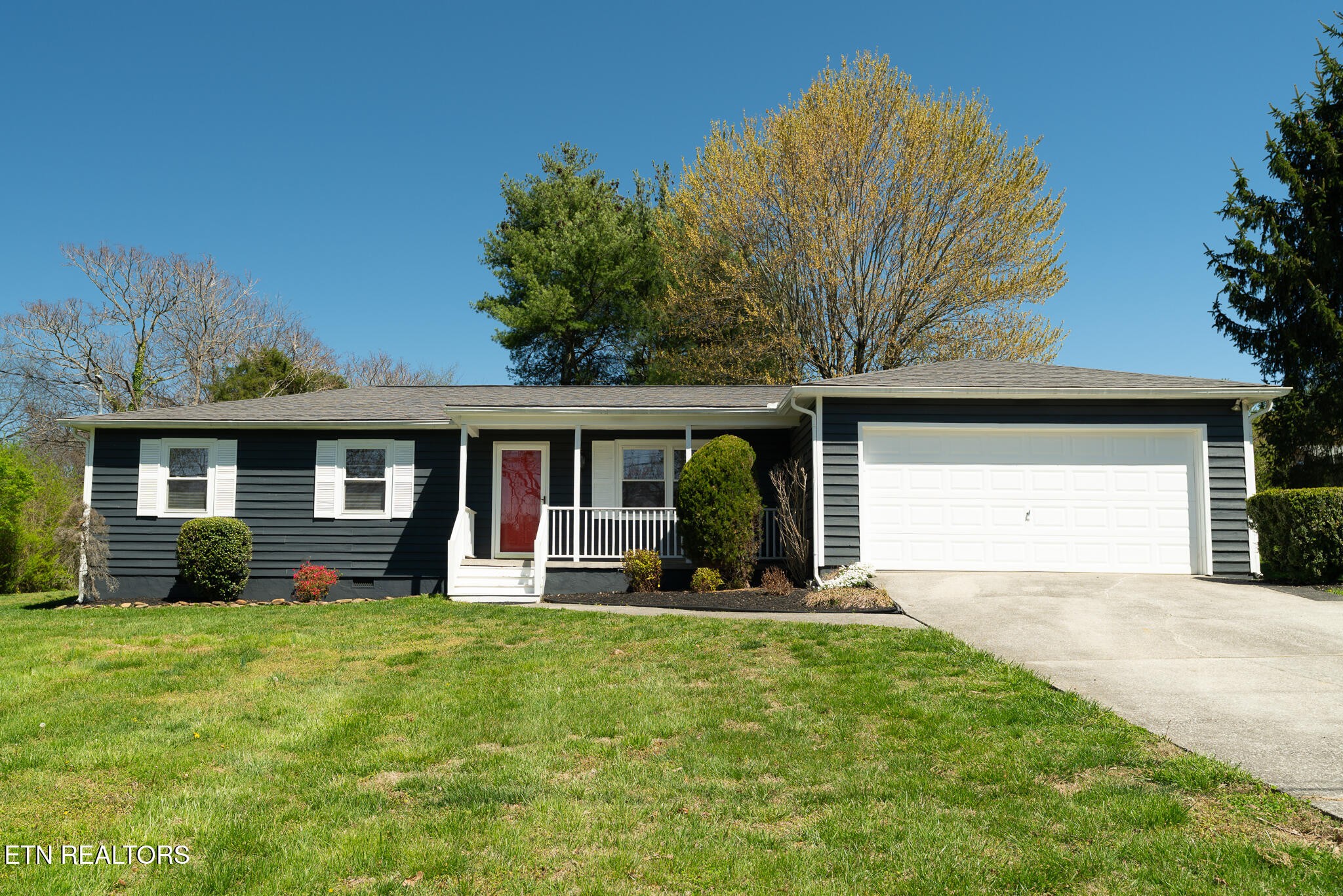 a front view of house with yard and green space
