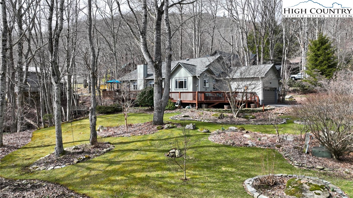 a view of a house with swimming pool and sitting area