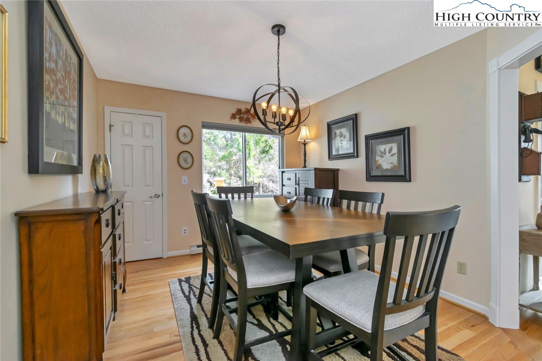 194 Woodwinds Circle Seven Devils, NC 28604 - Photo 18 of 50 a view of a dining room with furniture window and wooden floor