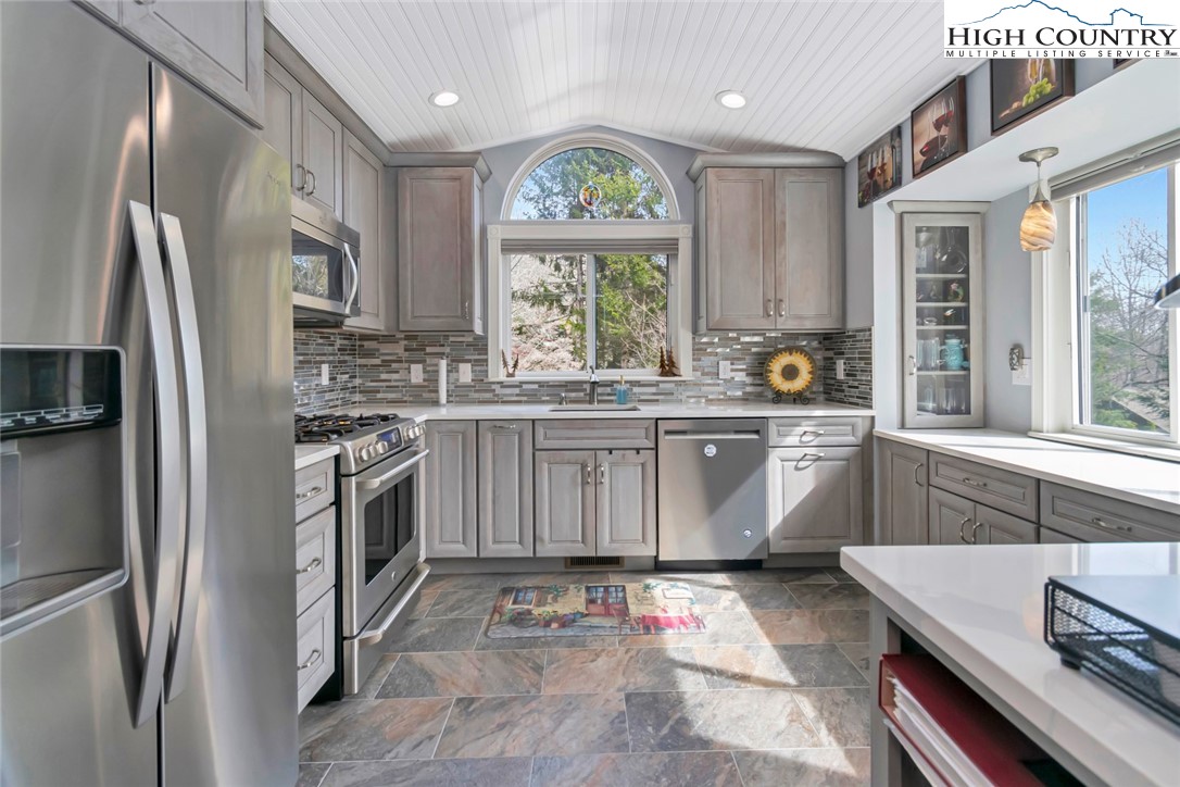 194 Woodwinds Circle Seven Devils, NC 28604 - Photo 19 of 50 a kitchen with stainless steel appliances granite countertop a stove a sink a refrigerator and a window