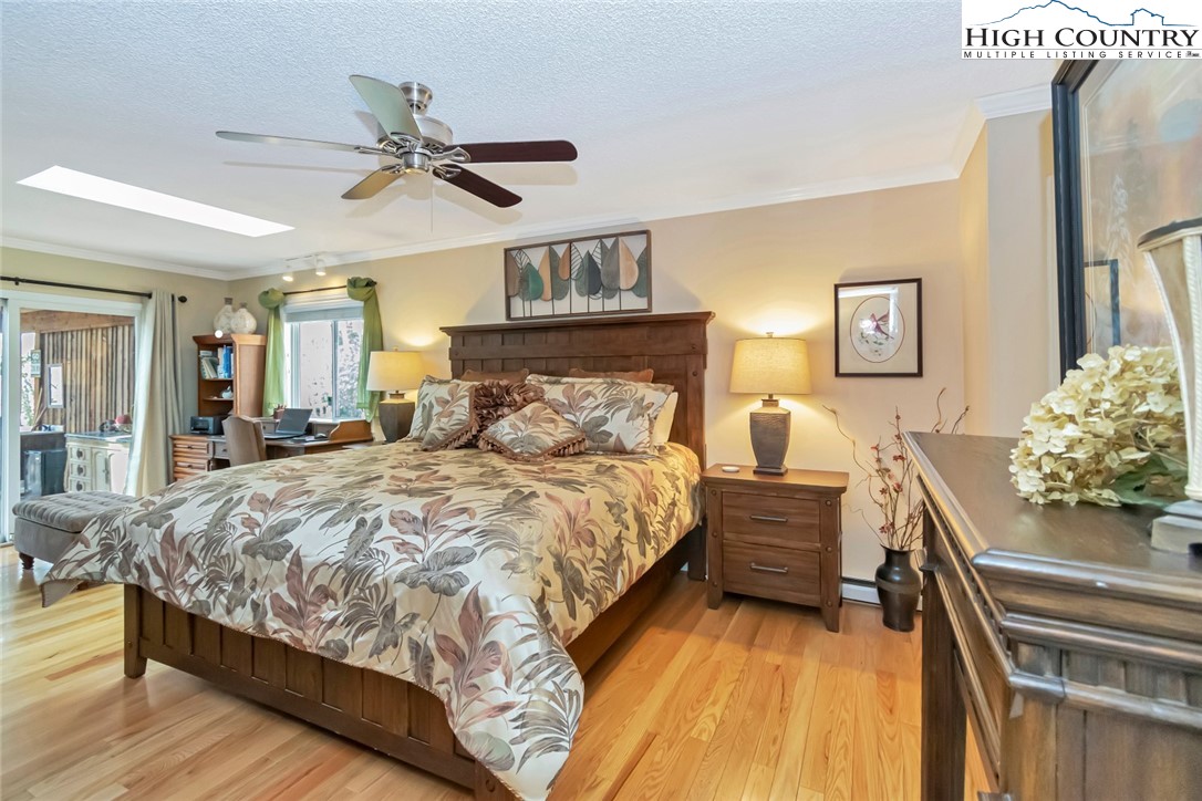194 Woodwinds Circle Seven Devils, NC 28604 - Photo 25 of 50 a bedroom with a bed and ceiling fan