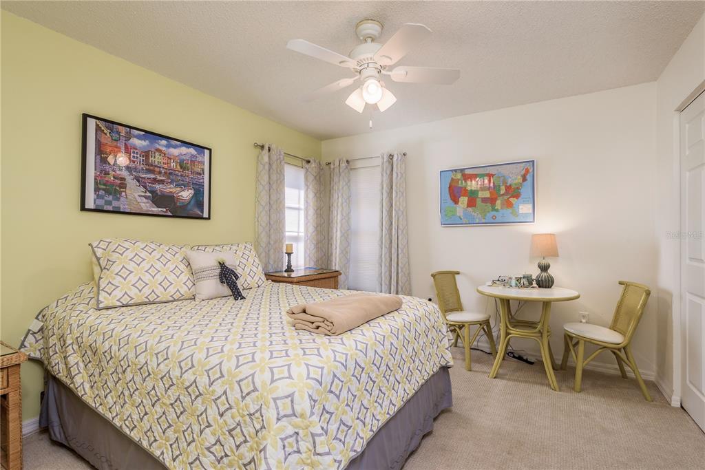 7536 Roland Court New Port Richey, FL 34654 - Photo 10 of 15 a bedroom with a bed and a table in it