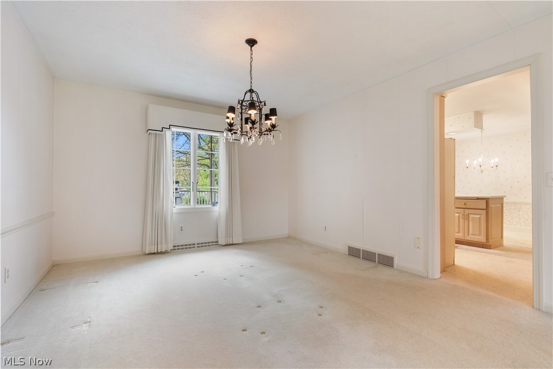 2240 Devonshire Road Northwest Canton, OH 44708 - Photo 6 of 36 Formal dining room with back window and chandelier.