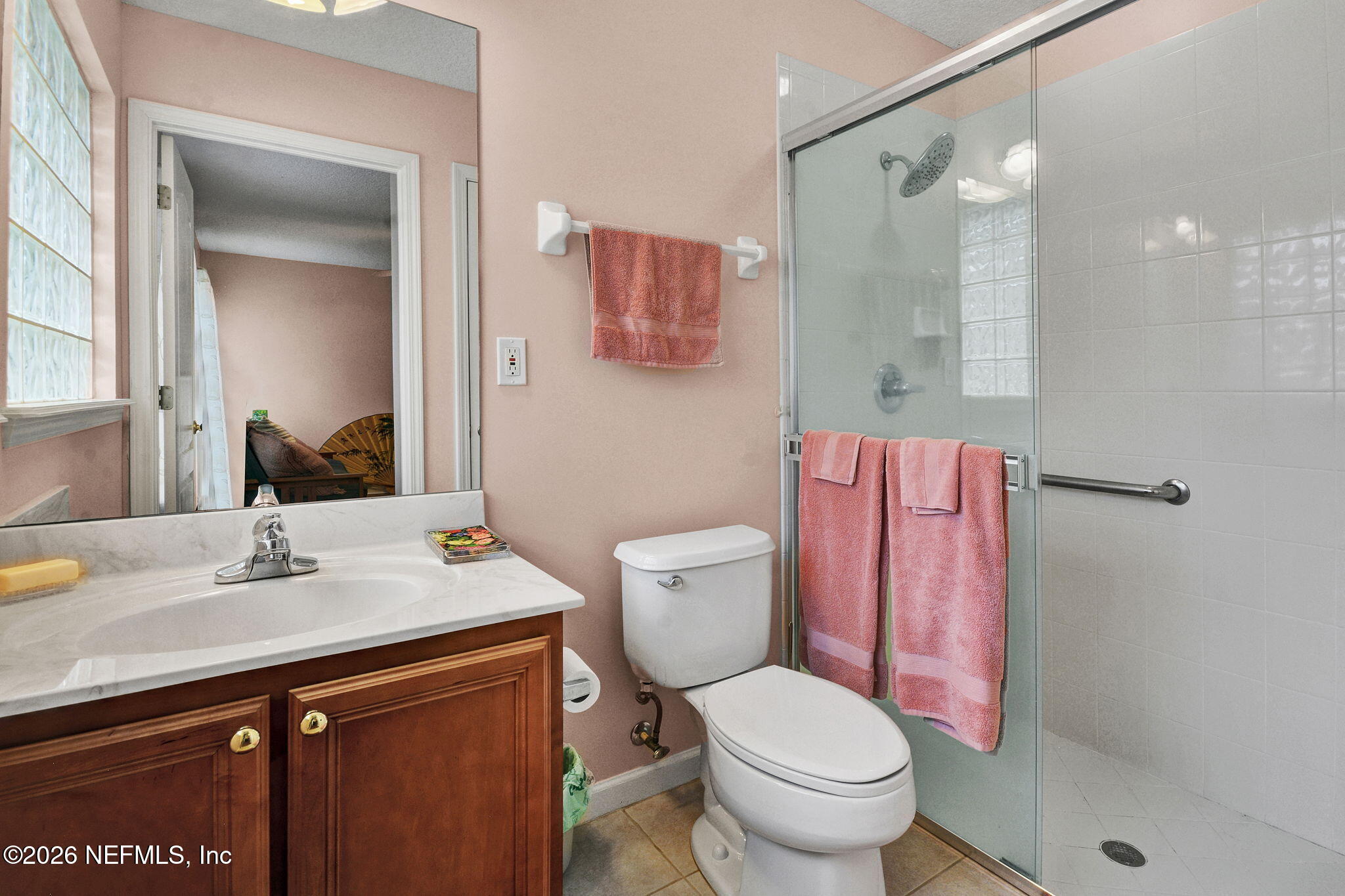 5950 West Shores Road Orange Park, FL 32003 - Photo 33 of 42 a bathroom with a sink toilet vanity and shower