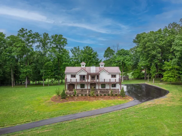 an aerial view of a house with swimming pool garden and patio