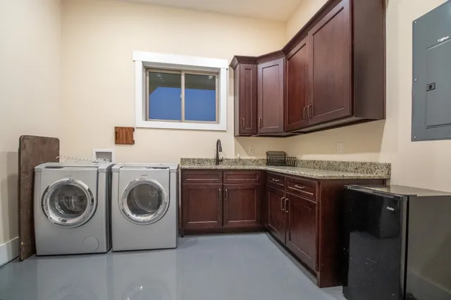 a utility room with sink dryer and washer