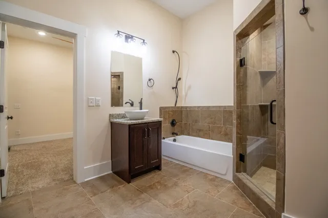 a bathroom with a tub sink and mirror