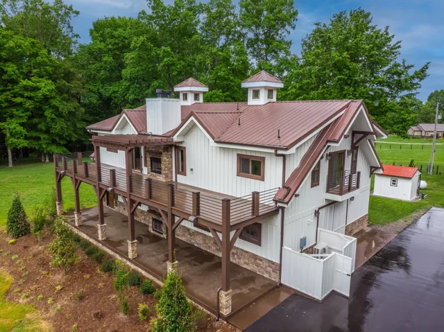 a aerial view of a house with a yard porch and furniture