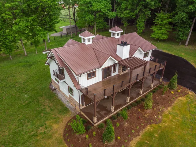 an aerial view of a house with a yard