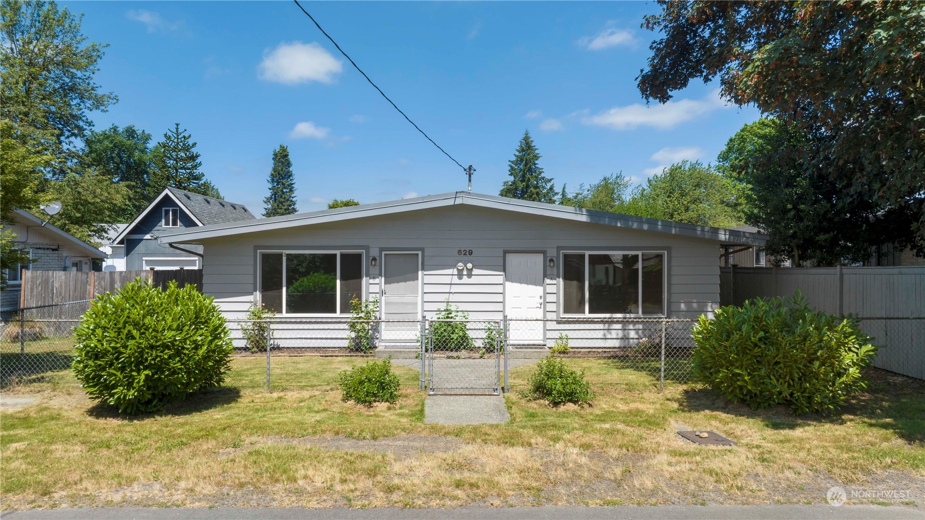 a front view of house with yard and green space