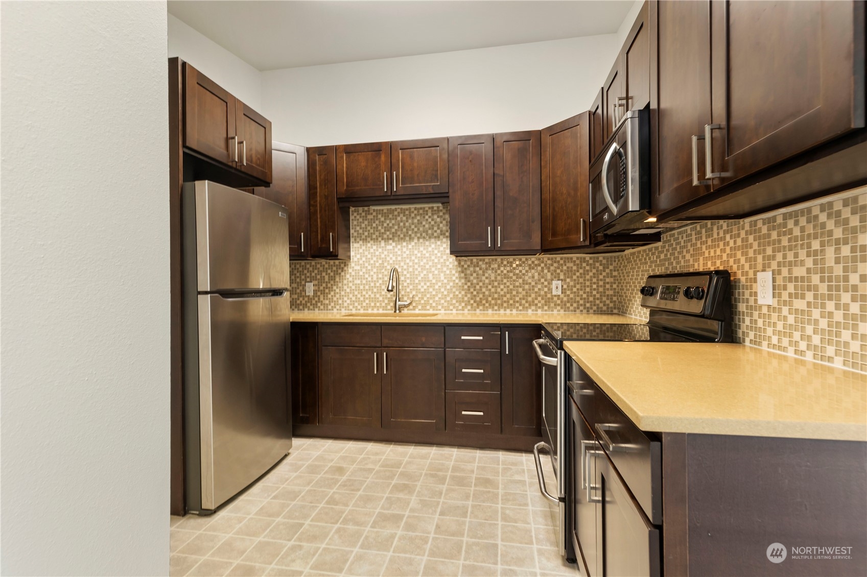 629 Monroe Street Monroe, WA 98272 - Photo 26 of 38 a kitchen with stainless steel appliances granite countertop a refrigerator a sink and wooden cabinets