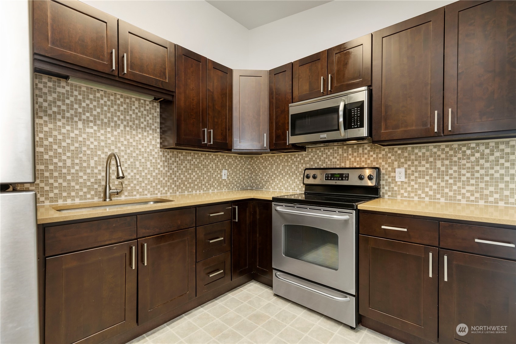 629 Monroe Street Monroe, WA 98272 - Photo 27 of 38 a kitchen with stainless steel appliances granite countertop a sink stove and microwave