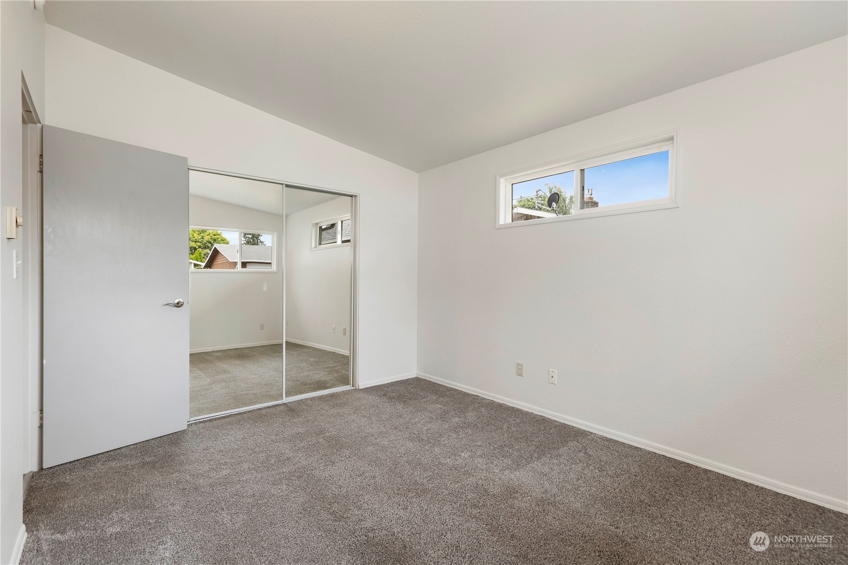 629 Monroe Street Monroe, WA 98272 - Photo 32 of 38 an empty room with closet and mirror