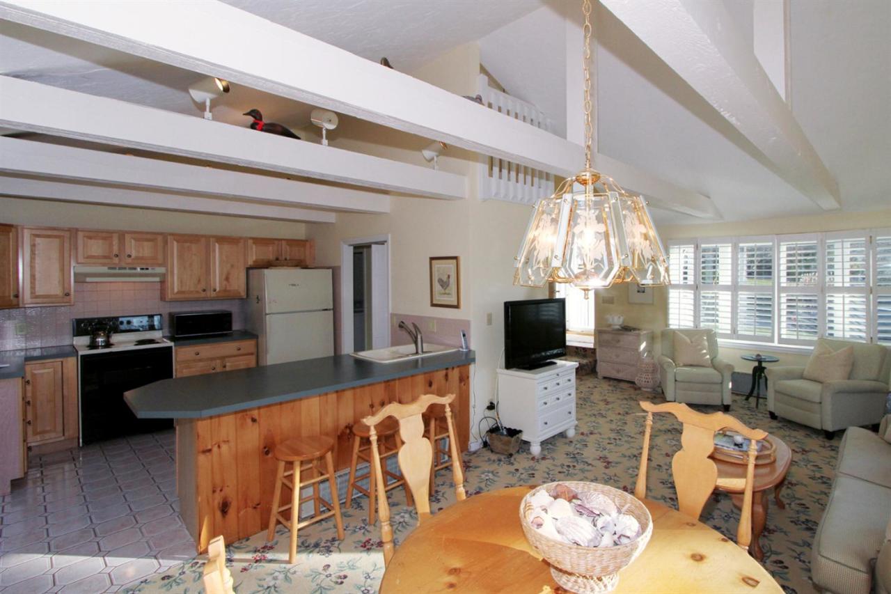 55 Barley Neck Road Orleans, MA 02653 - Photo 14 of 32 a living room with fireplace furniture and a flat screen tv