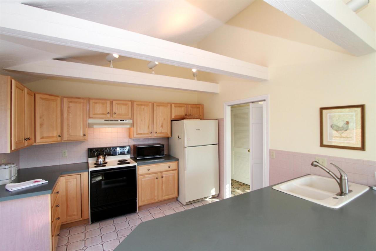 55 Barley Neck Road Orleans, MA 02653 - Photo 17 of 32 a kitchen with stainless steel appliances granite countertop a refrigerator sink stove and oven