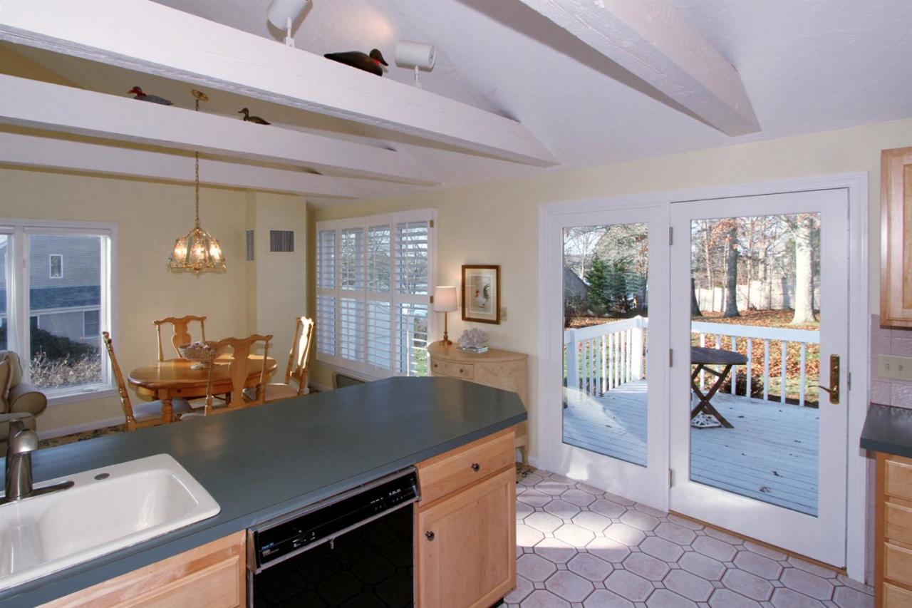 55 Barley Neck Road Orleans, MA 02653 - Photo 19 of 32 a kitchen with a table chairs and refrigerator